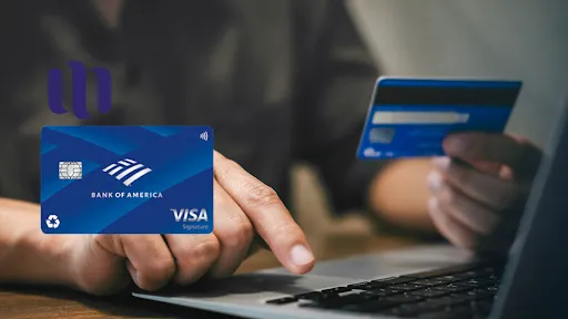 man holds credit card and types on notebook