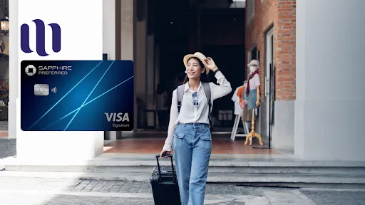 woman smiles walking with hat, sunglasses, backpack and suitcase