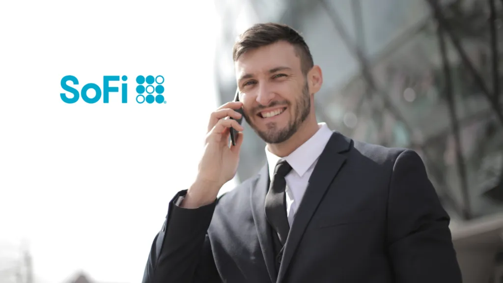 Man in suit talking on cell phone and smiling.