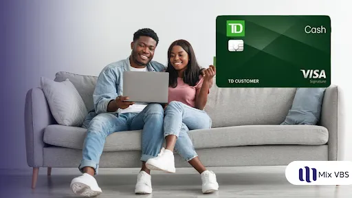 couple-sitting-on-the-couch-smiles-while-looking-at-the-laptop-screen-and-the-woman-is-holding-a-card